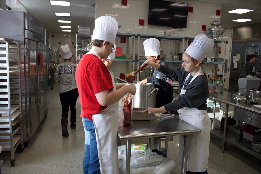 Culinary Students cooking in kitchen