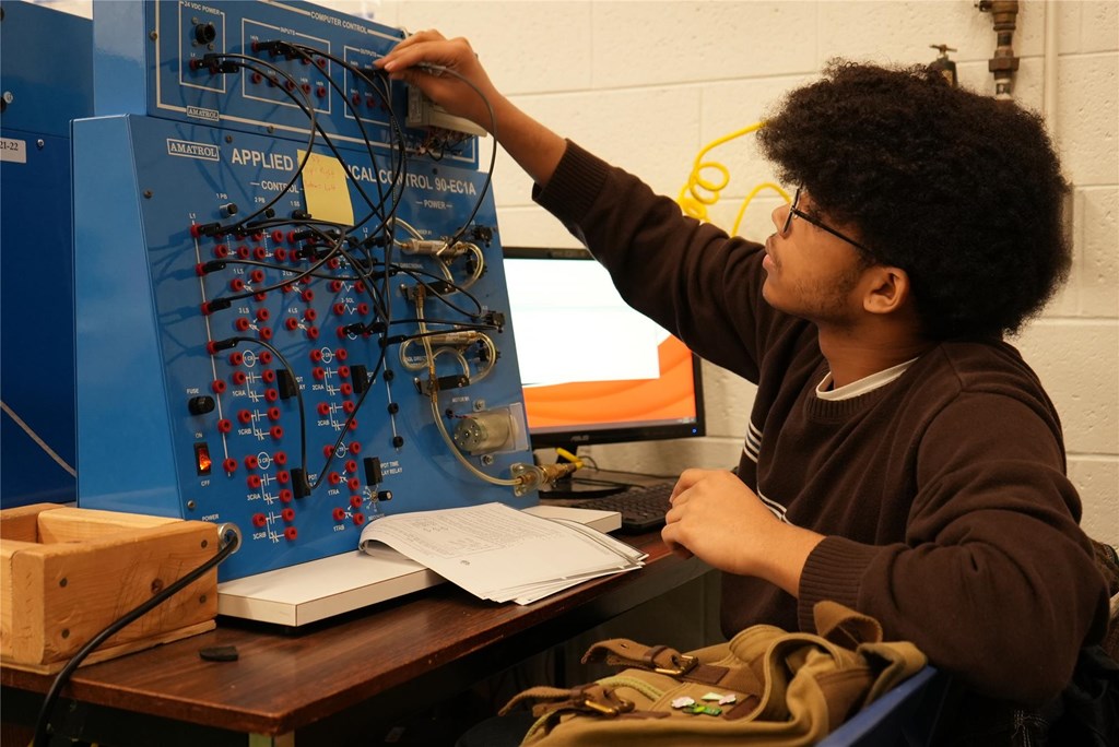A student works at a station in the Robotics & Engineering classroom.